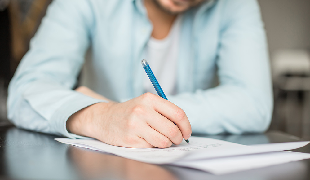 Man writing handwritten letter Man writing handwritten letter