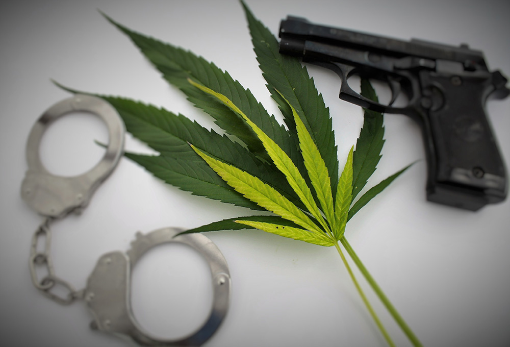 Beretta M9 with marijuana plant leaf and handcuffs Beretta M9 with marijuana plant leaf and handcuffs