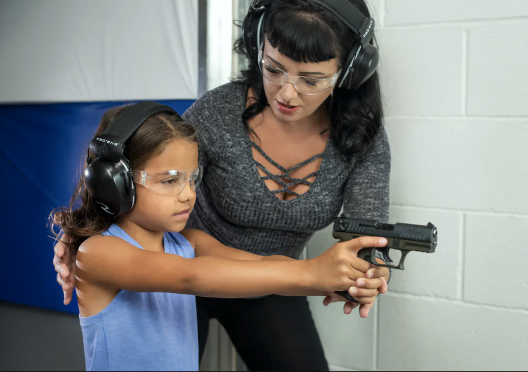 small size child with walther pistol and gun range